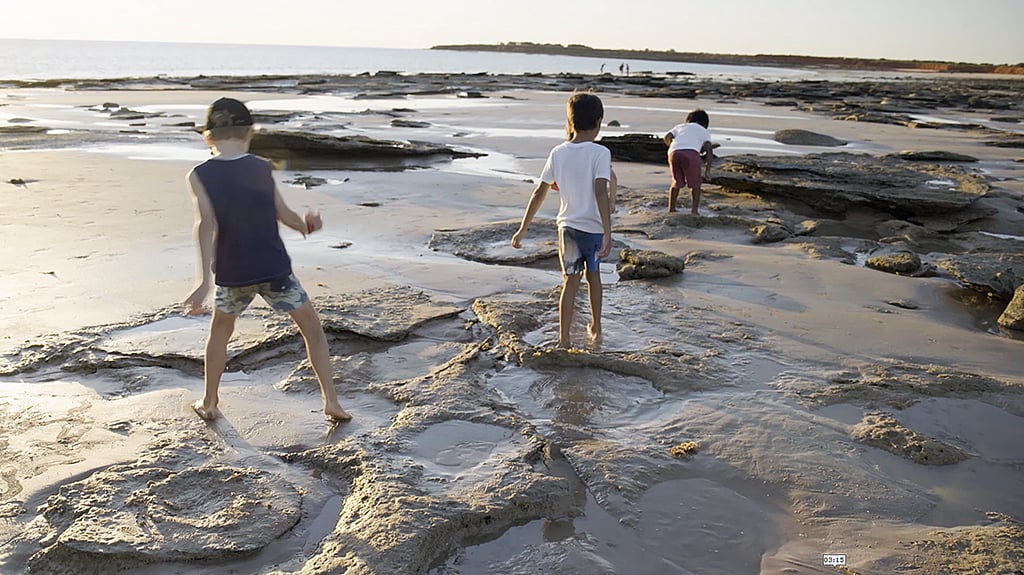 Kids exploring dinosaur footprints in Broome