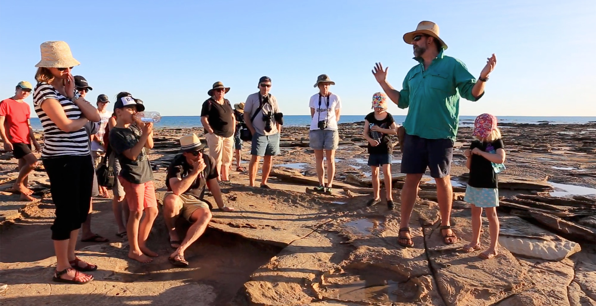 Kids exploring dinosaur footprints in Broome